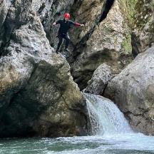 osoba koja skače sa stijene u vodopad