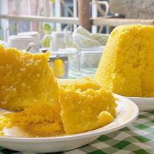 two pieces of yellow cake on a plate on a table