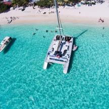an aerial view of a boat in the water near a beach