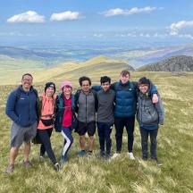 a group of people standing on top of a hill