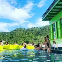 a group of people in the water in a pool