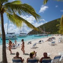 a group of people sitting on a beach