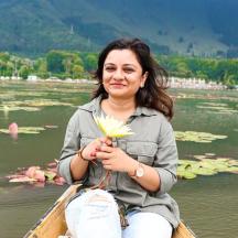 a woman sitting in a boat holding a flower