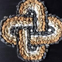 a woven rug with a peace sign on a table