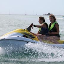 two people riding on a jet ski in the water