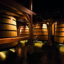 a row of wine barrels in a wine cellar
