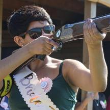 a woman holding a large gun in her hand