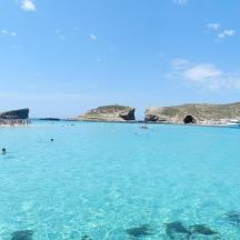 a group of people swimming in the blue ocean