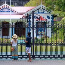 a man and a woman standing in front of a gate