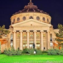 a large building with a green lawn in front of it