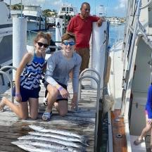a group of people on a boat with fish