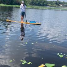 a man standing on a paddle board in the water