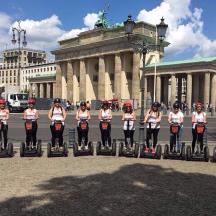 a group of women in uniform on segways in front of a building