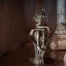a silver statue sitting on top of a table