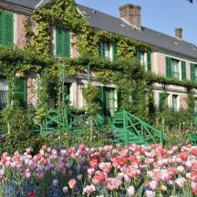 a large house with flowers in front of it