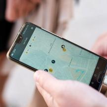 seseorang yang memegang telefon bimbit dengan peta