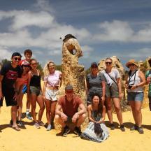 a group of people standing in front of a statue