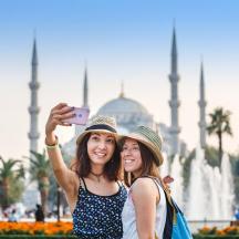 two women taking a picture of the blue mosque