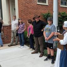 a group of people standing outside of a house