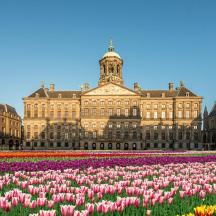 a large building with flowers in front of it