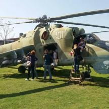 a group of people standing in front of a helicopter