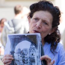 a woman holding a picture of a building
