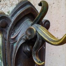 a metal door handle with a snake on it