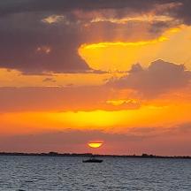 un vaixell a l'aigua amb una posta de sol