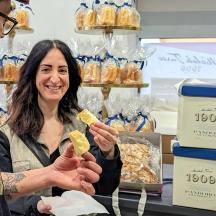 a man and a woman eating food in a store