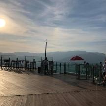 a group of people standing on a wooden deck