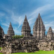 a large stone building with tall towers on a field