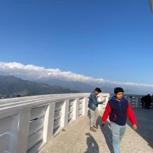 a group of people walking on a bridge