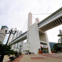 a building with a bridge with benches in front of it