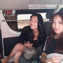 two women sitting in the back of a car