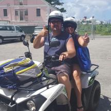 a man and a woman sitting on a motorcycle
