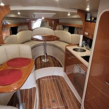 an interior of an rv with a table and a kitchen
