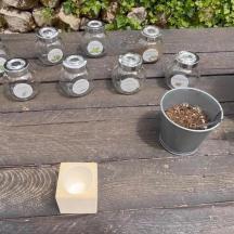 a group of jars and a bucket on a wooden bench
