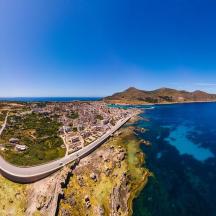 an aerial view of a road next to the ocean