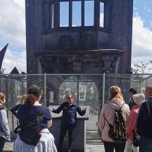 a group of people standing outside of a glass building