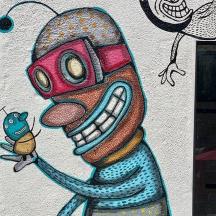 a wall with a painting of a monster and a fish