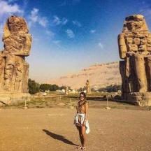 a woman standing in front of two large rock formations