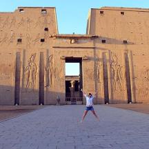 a woman standing in front of a building with writing on it