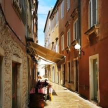 an alley in an old town with buildings