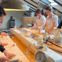 a group of women in a kitchen preparing food