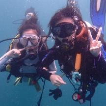 a group of people in the water making the peace sign