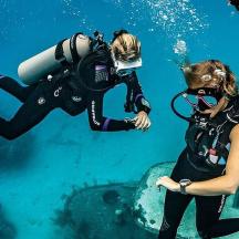 a woman scuba diver with a camera in the water