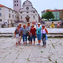 a group of people standing in front of a building