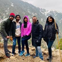 a group of people standing on top of a mountain
