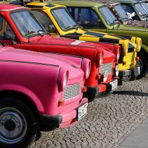 a row of colorful old trucks parked in a row