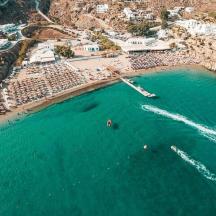 an aerial view of a beach with boats in the water